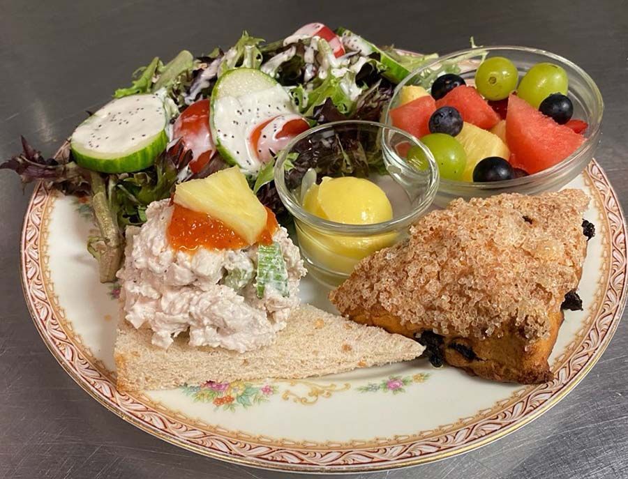 Savory, small salad, fruit cup, half scone and lemon curd, and pot of tea.