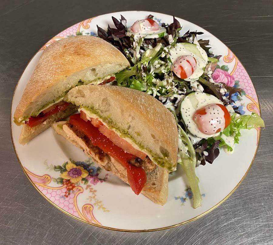 Grilled Chicken salad Sandwich and a salad.