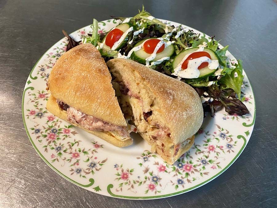 Turkey and Brie sandwich with a salad.