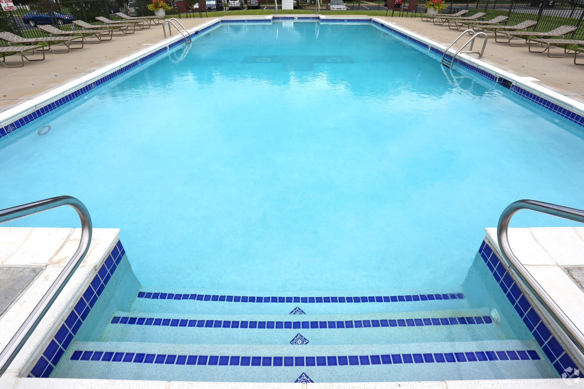 A large swimming pool with stairs leading to it