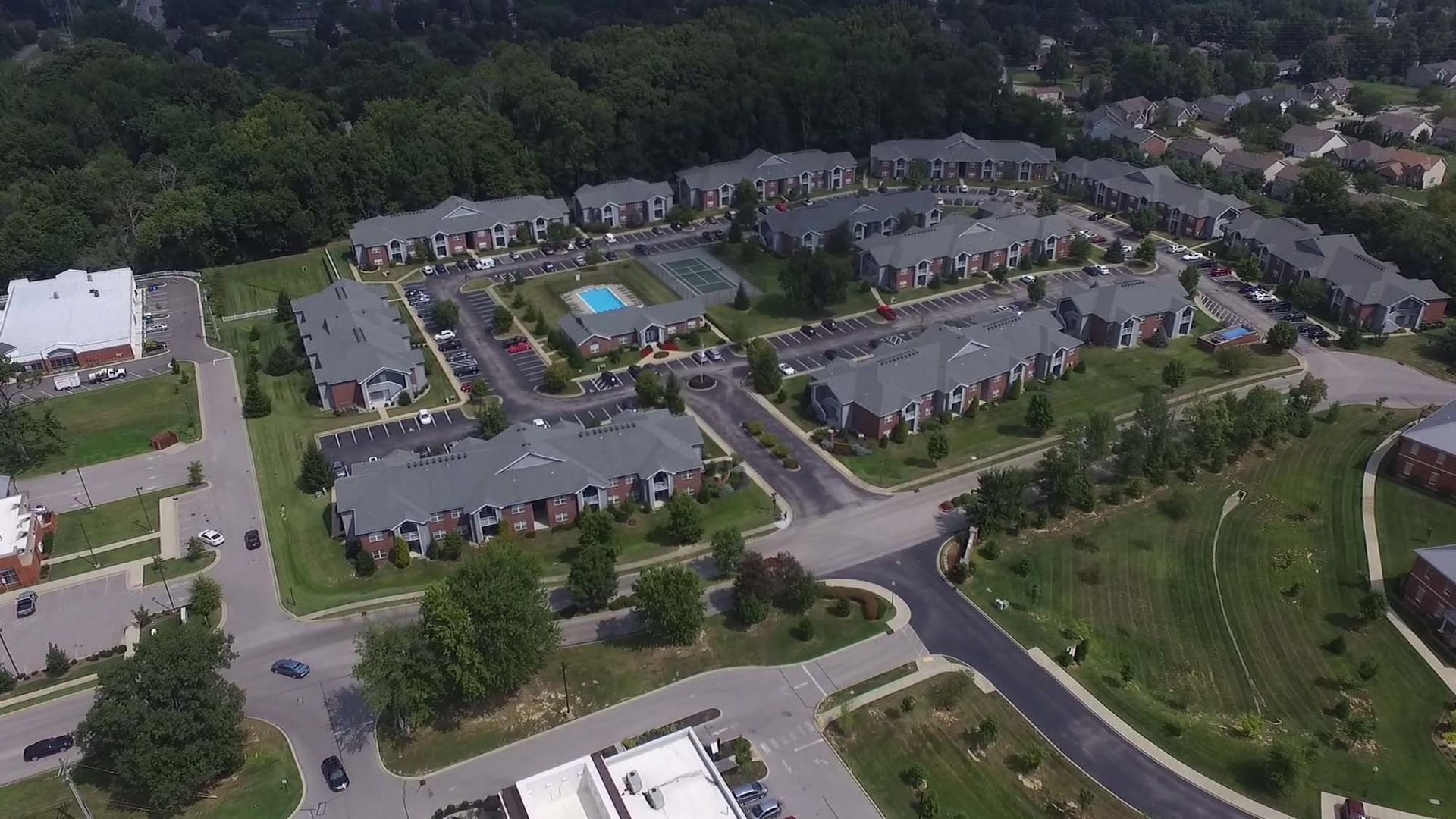 An aerial view of a residential area with lots of buildings and trees.