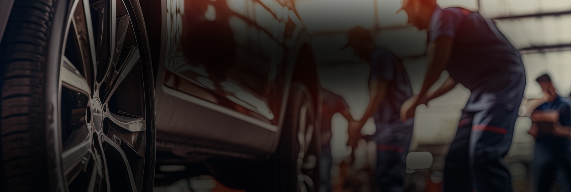 Up close of car in garage, technicians at work | Innovative Auto Service