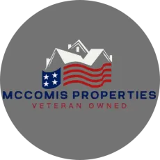 Logo of McComis Properties, a veteran-owned real estate company, with a house silhouette and American flag design.