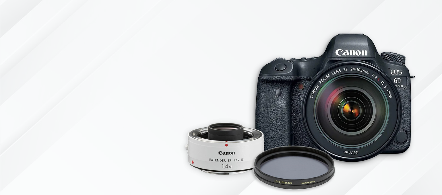 A black canon camera is sitting on a white surface.