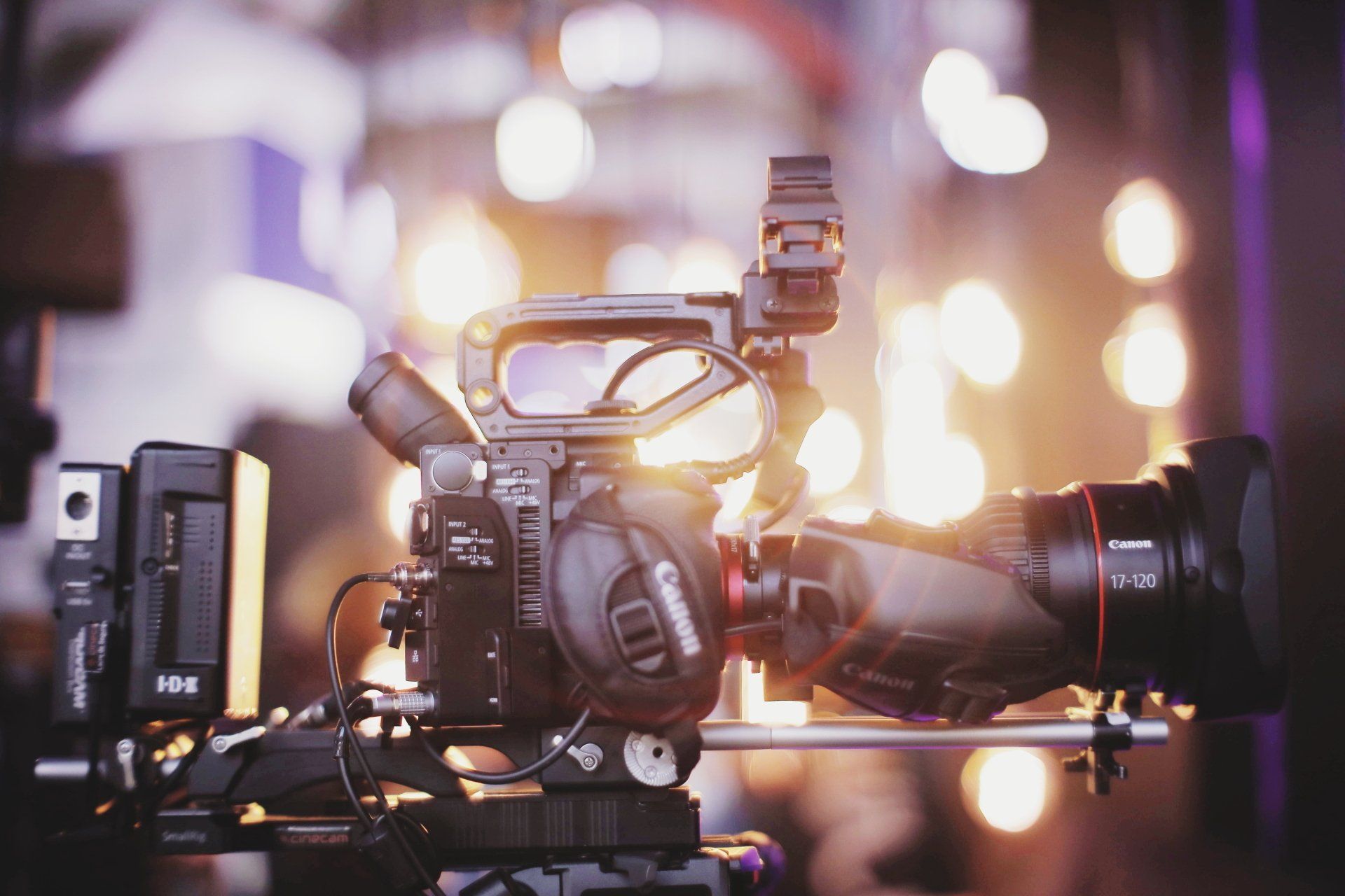 A close up of a video camera on a tripod.