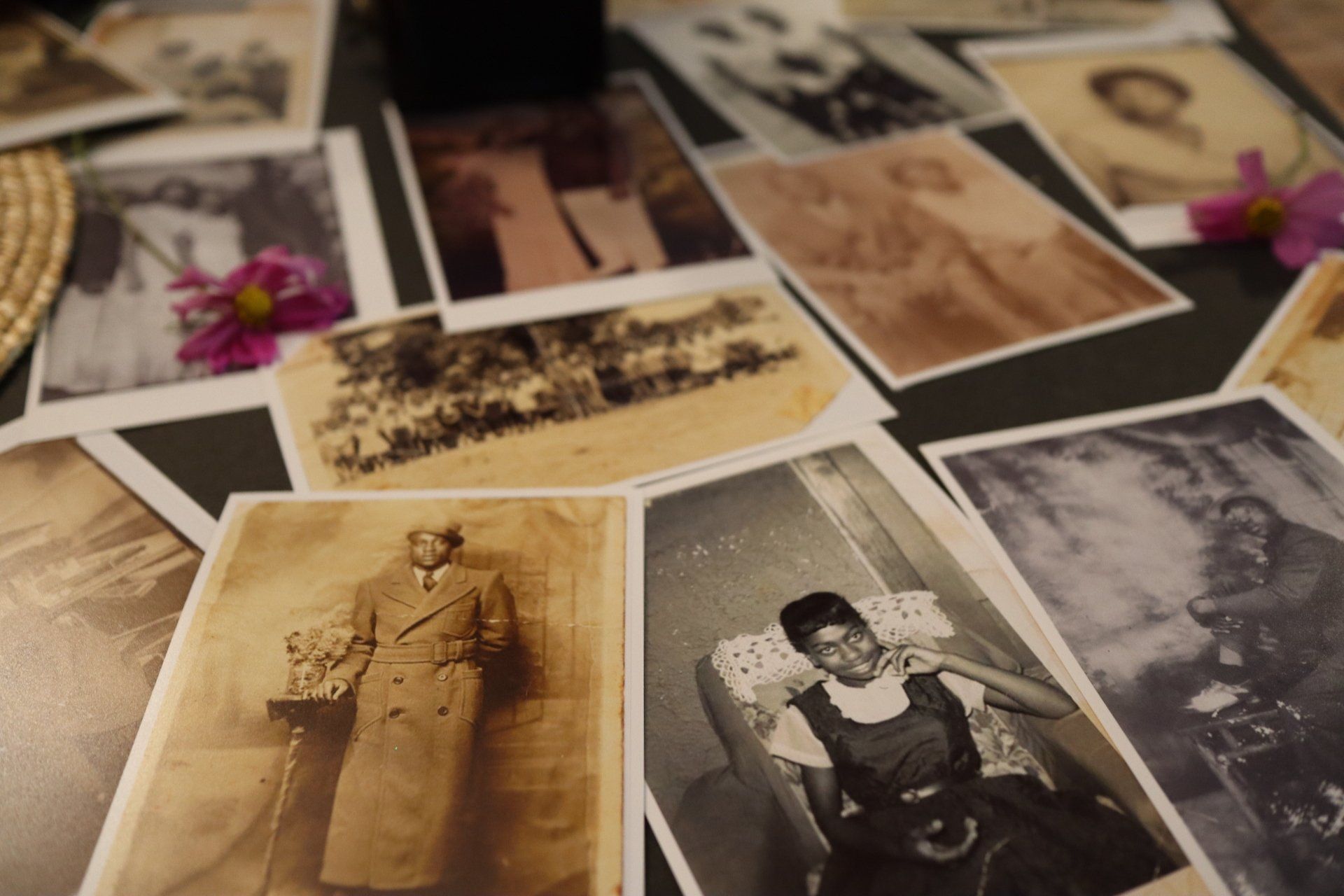 A bunch of old black and white photos on a table