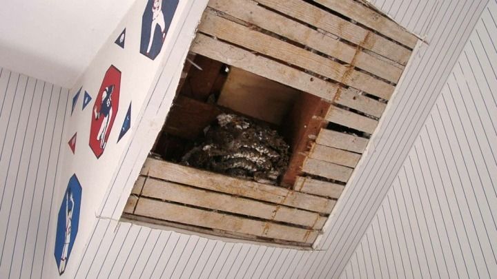 A hole in the ceiling with a sign on it