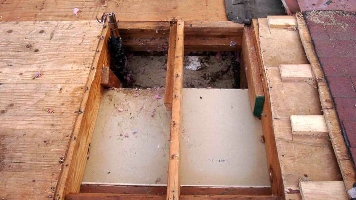 A wooden floor with a hole in the middle of it.