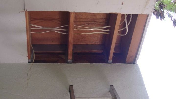 A ladder is hanging from the side of a building