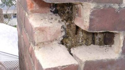 A close up of a brick wall with a hole in it.