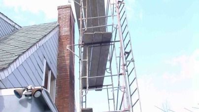 A brick building with scaffolding on the side of it.