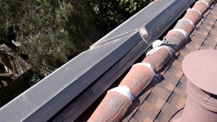 A roof with a gutter and a chimney on it