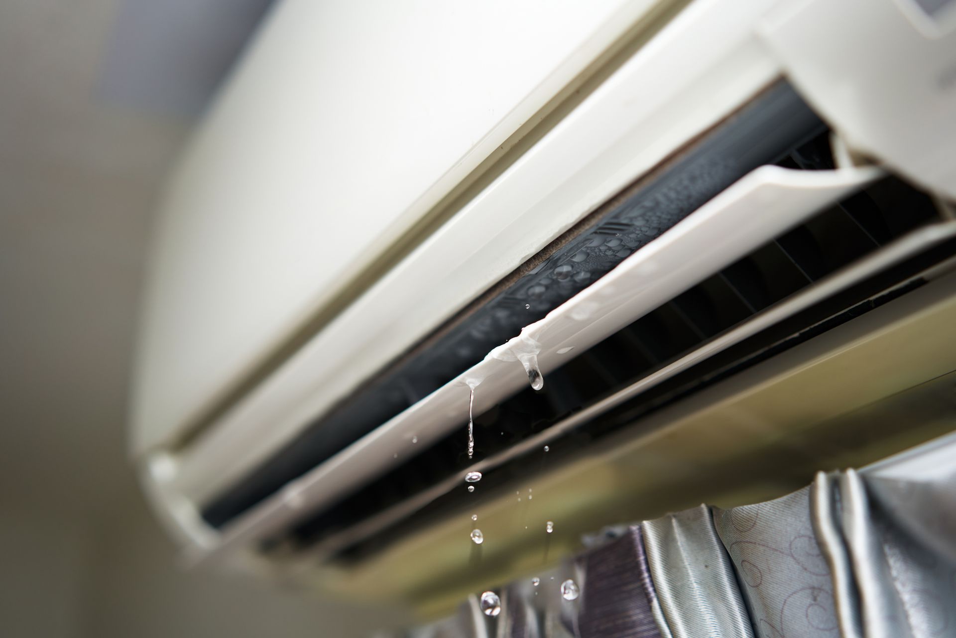 A close up of an air conditioner with water leaking out of it