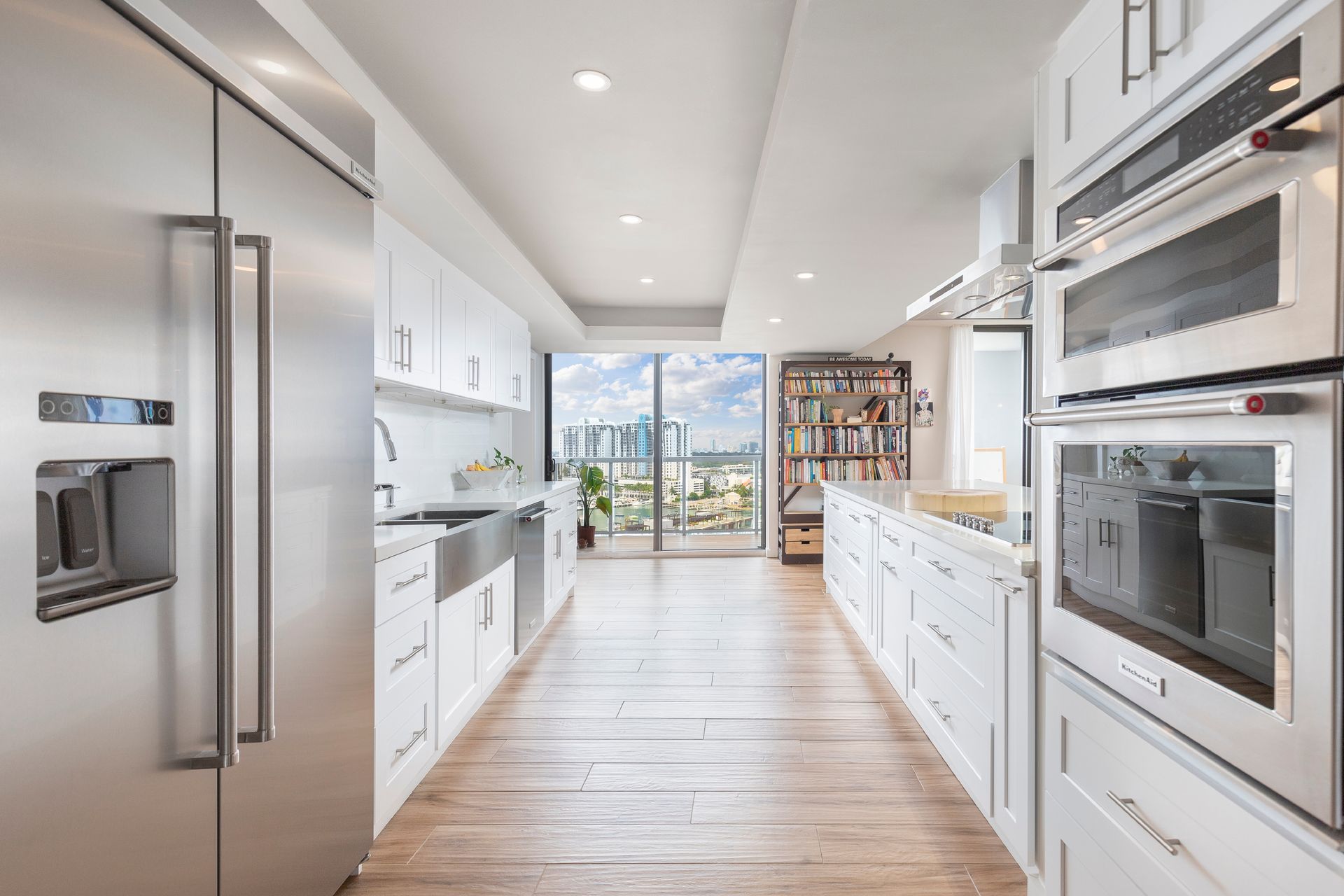 A kitchen with stainless steel appliances and white cabinets.