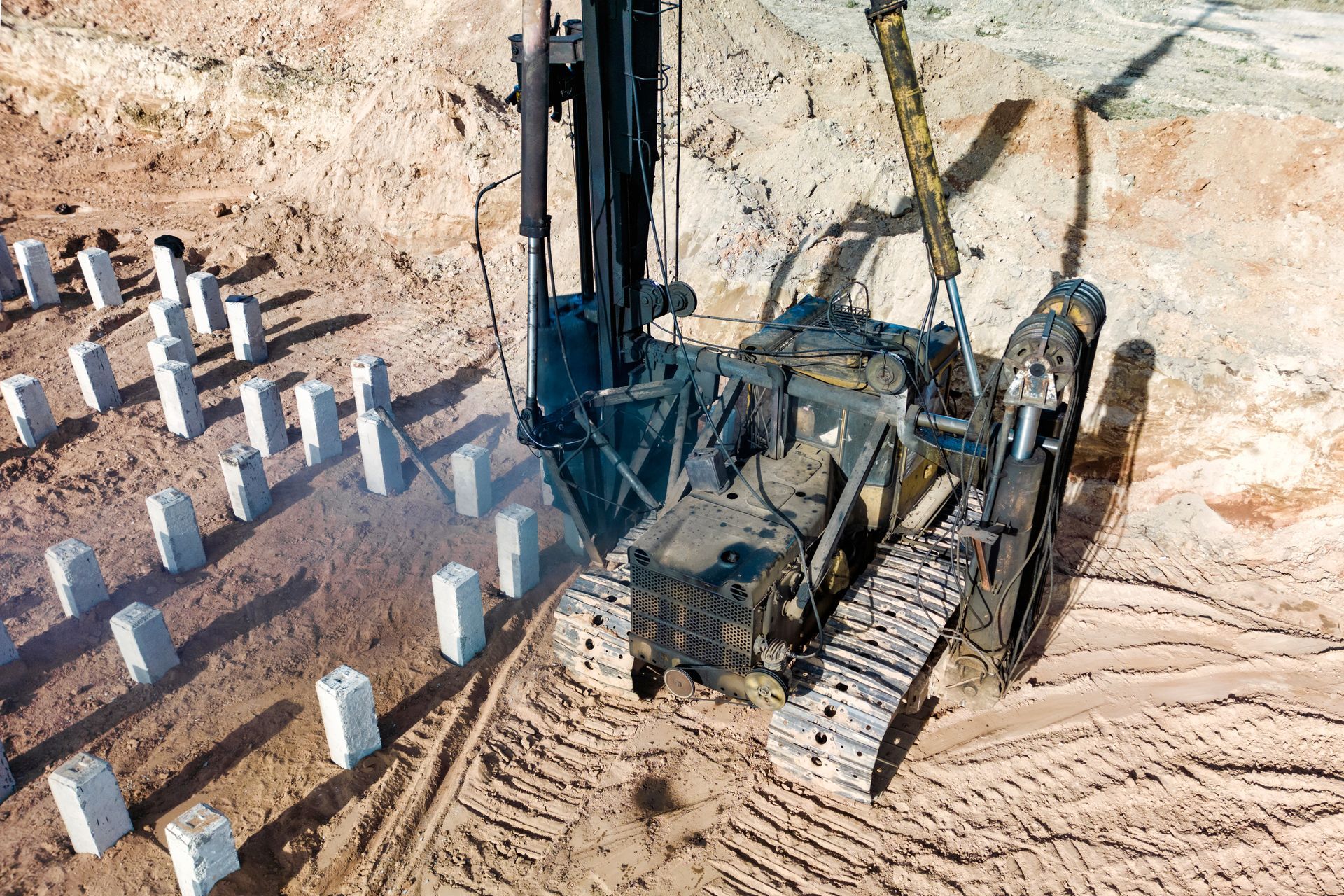 A pile driving machine preparing a pile foundation on a construction site.