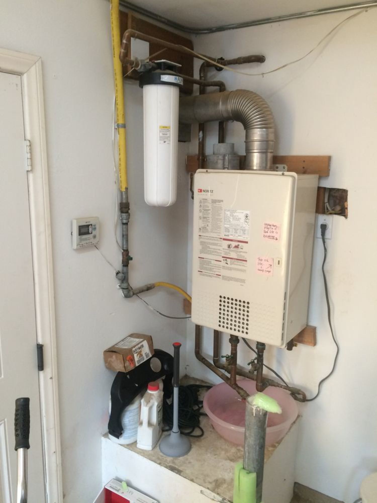 A water heater is sitting on a counter in a room.
