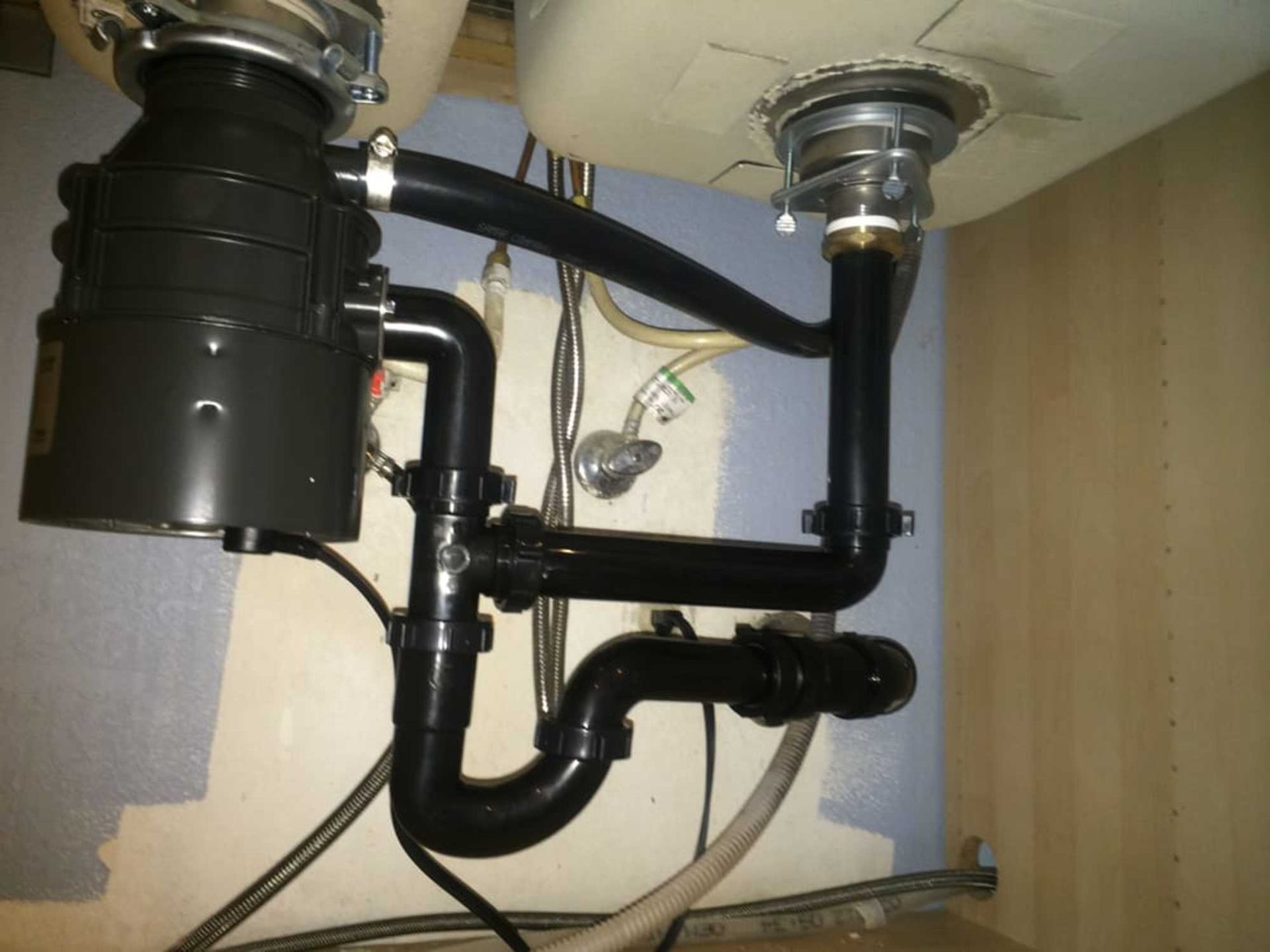 A sink with a garbage disposal attached to it