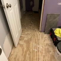 A room with a wooden floor and a door.