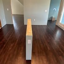 There is a wooden divider in the middle of the room.