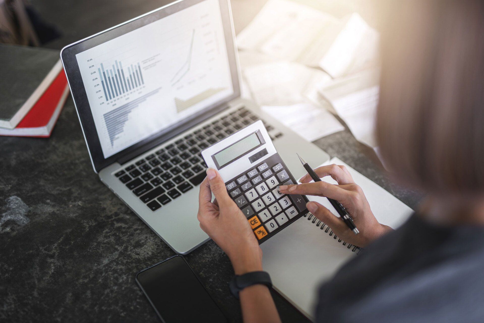 Woman Using a Calculator — Missoula, MT — McNay & Messick, CPAs, PC