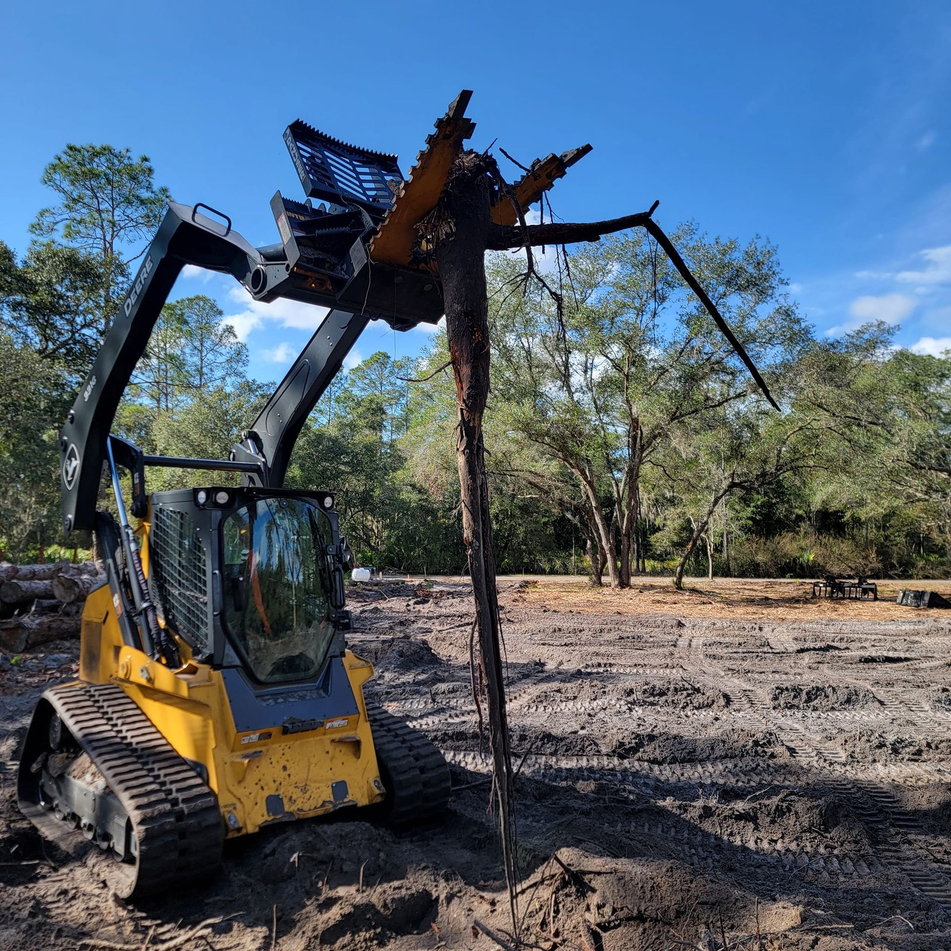 A yellow tractor with a statue of a mosquito on top of it