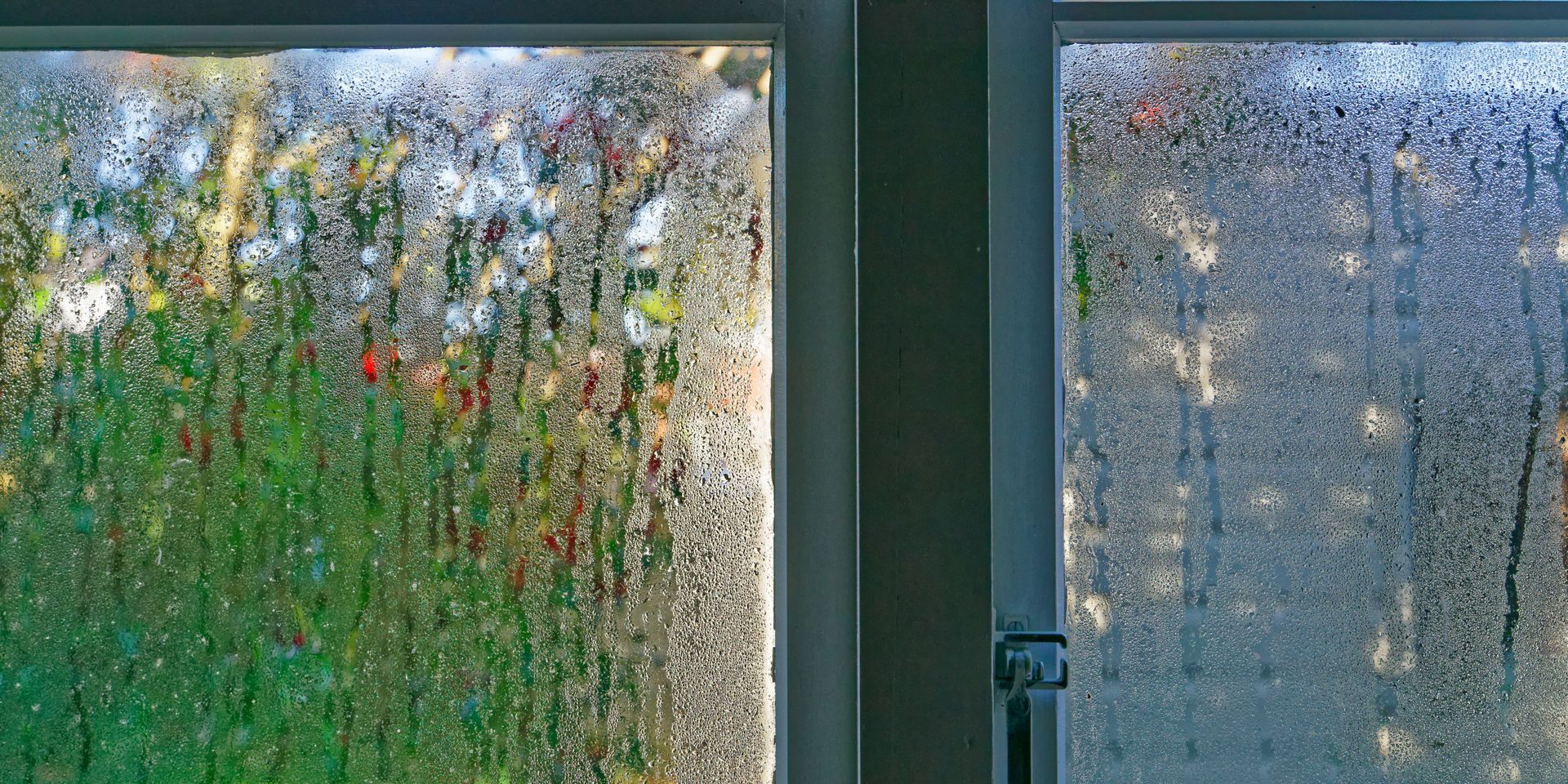 A close up of a window with condensation on it.
