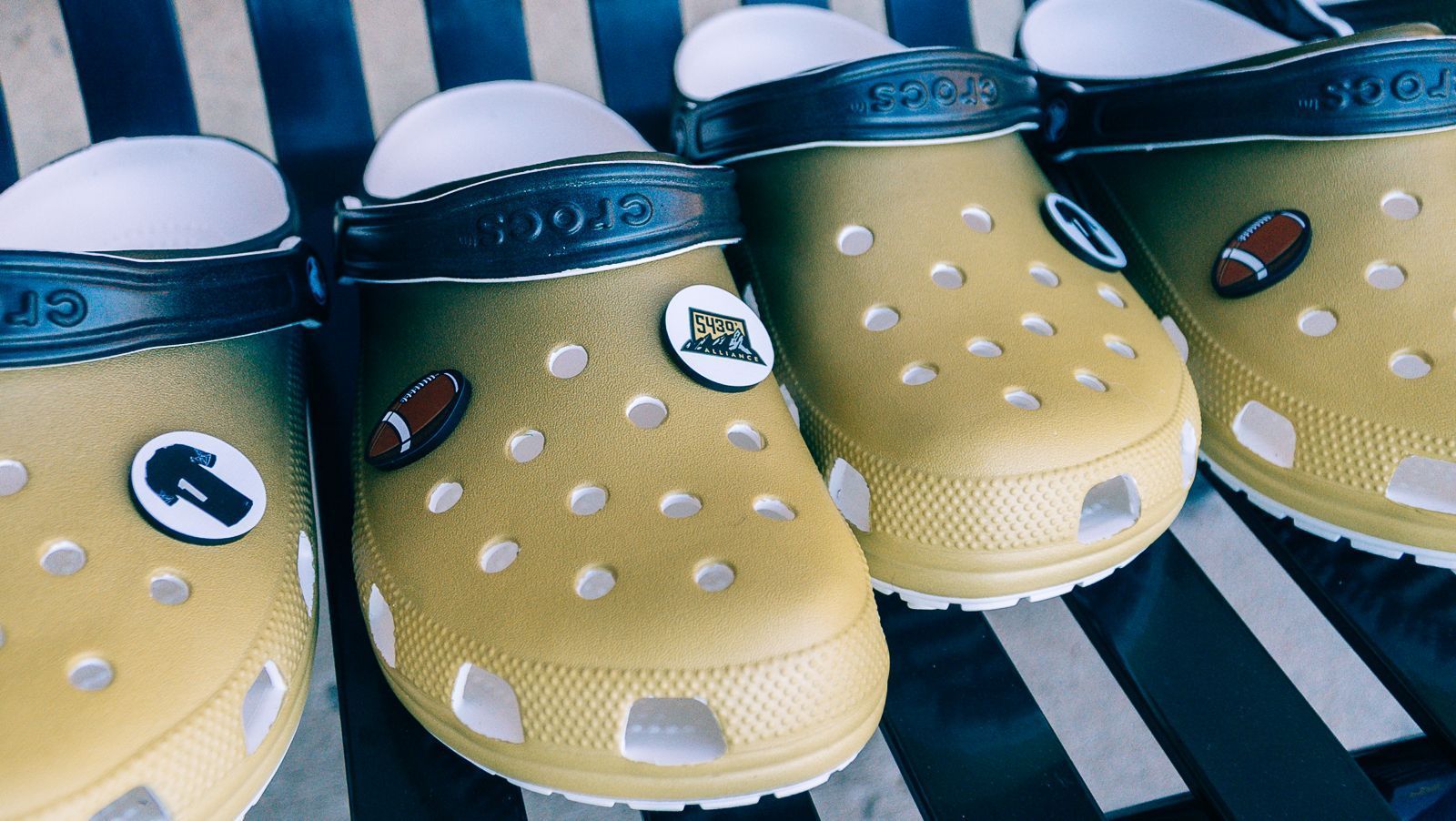 A row of crocs with a football on them