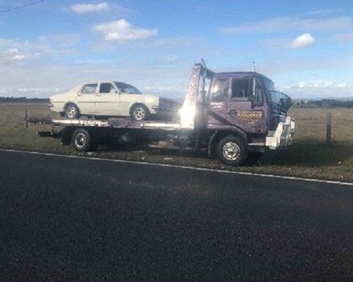 Truck towing a white car