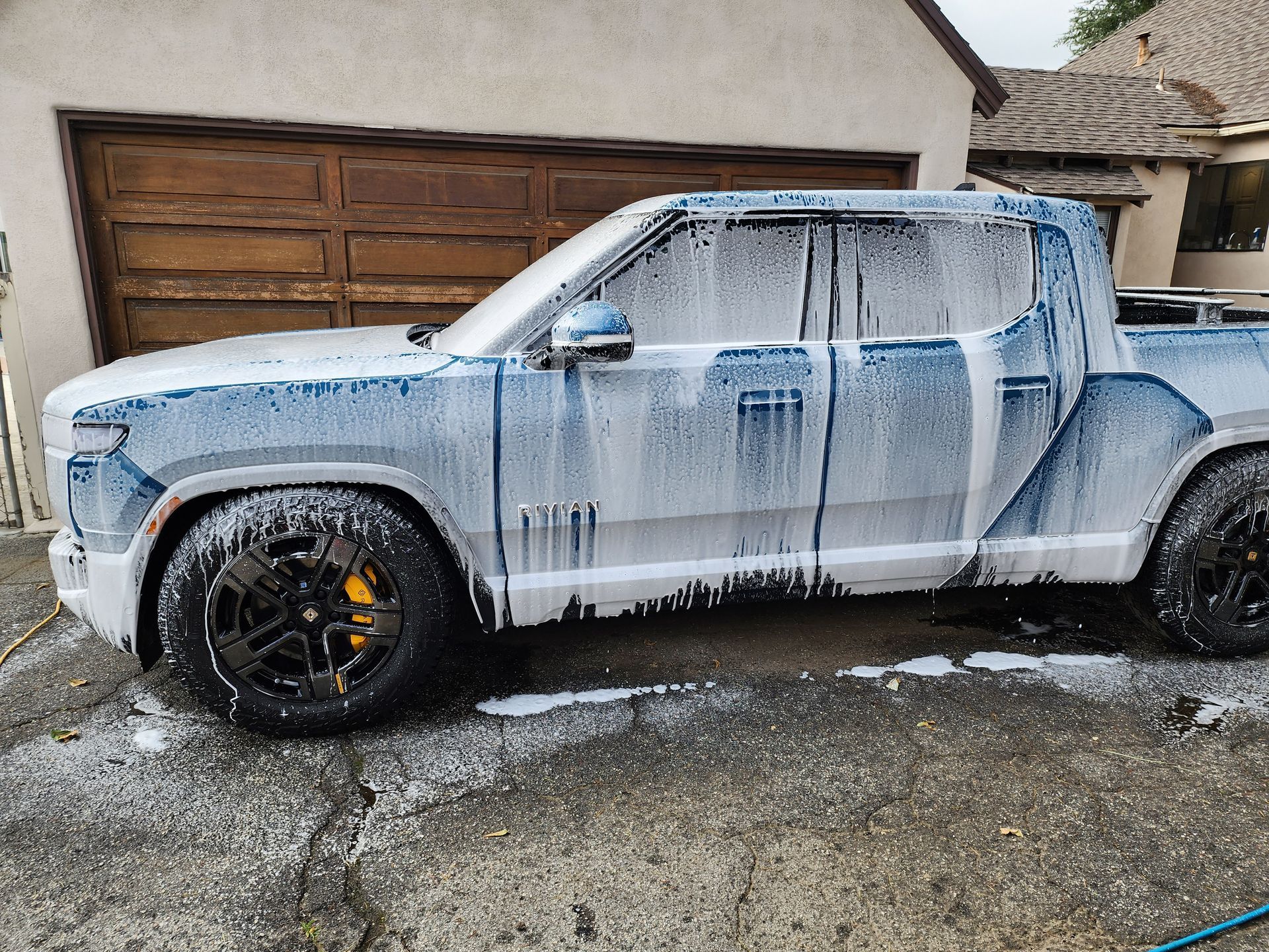 A Rivian truck getting washed.