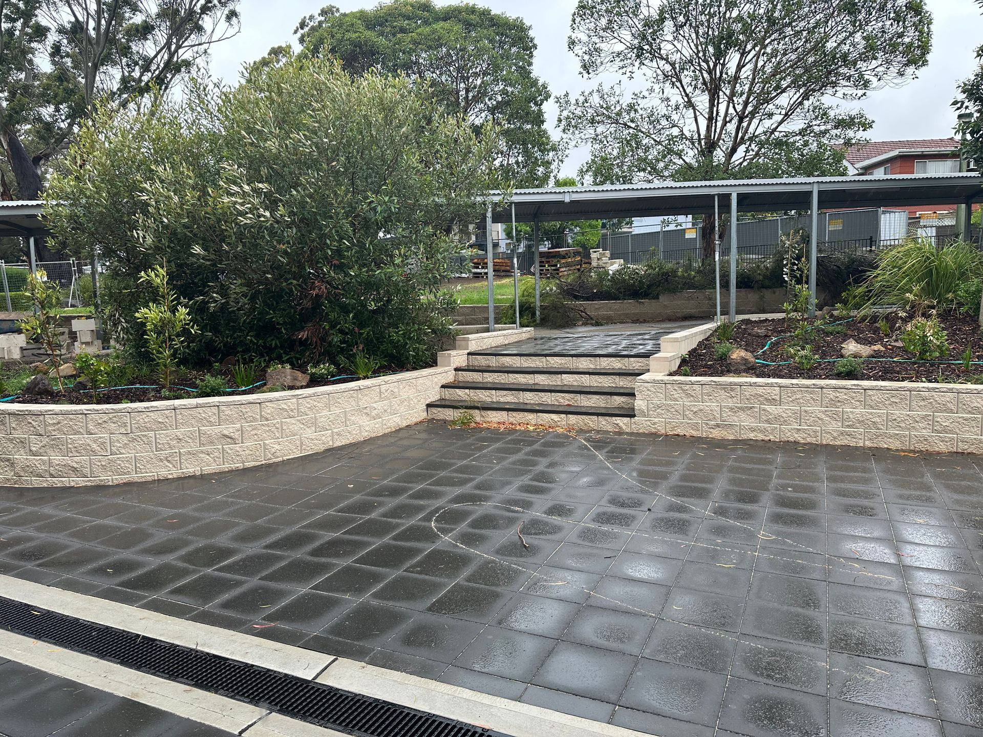 A hose is being used to clean the sidewalk in front of a building.