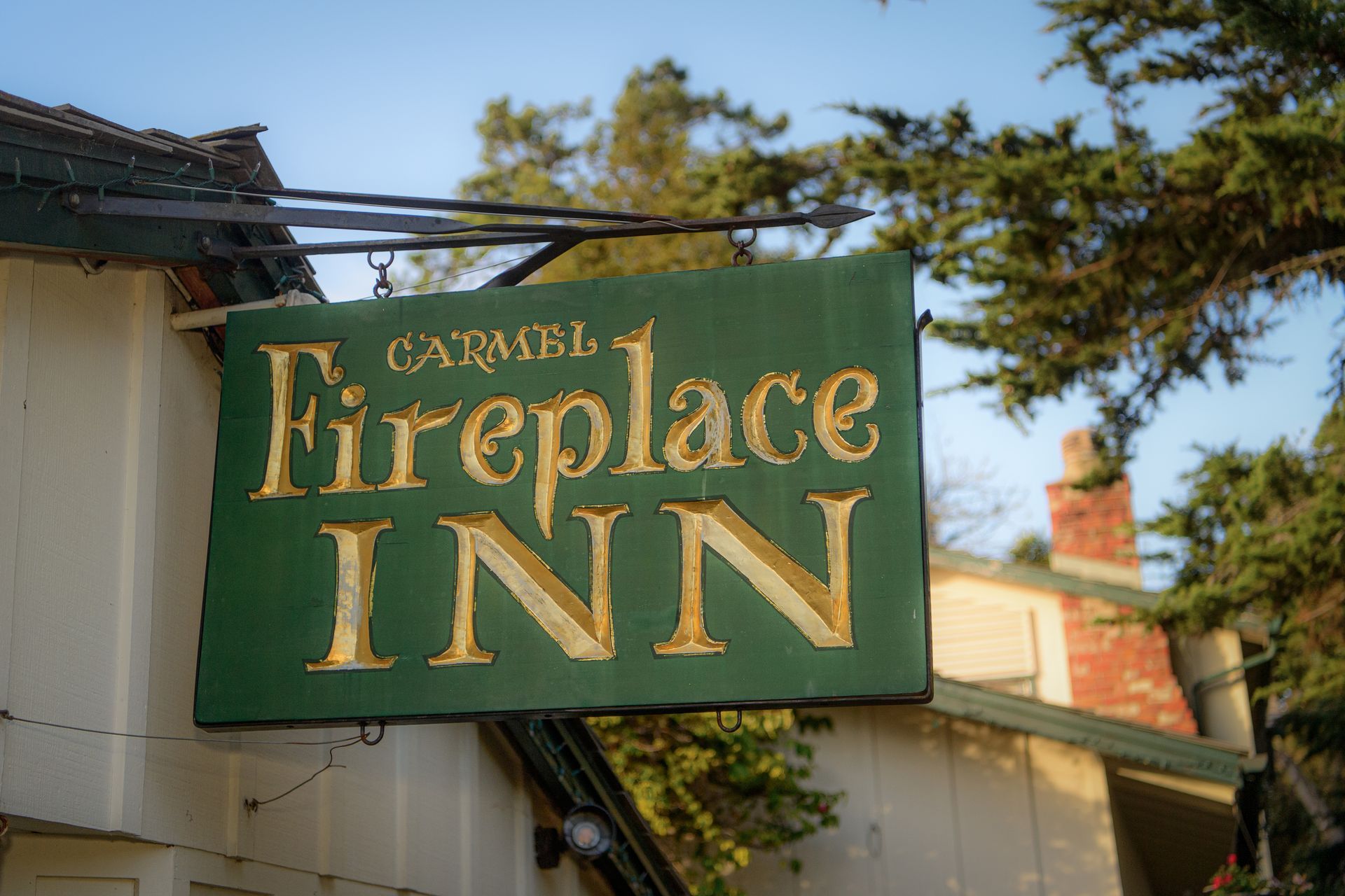 A sign for the fireplace inn hangs from the side of a building