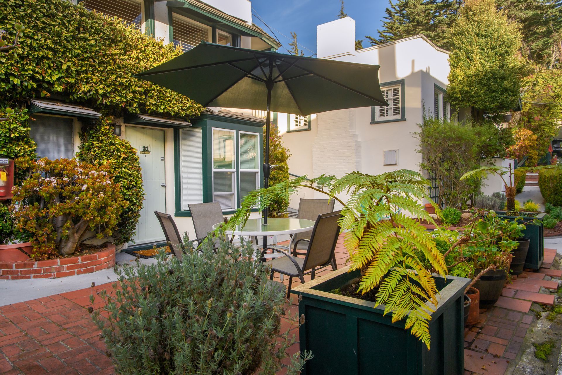 A patio with a table and chairs under an umbrella