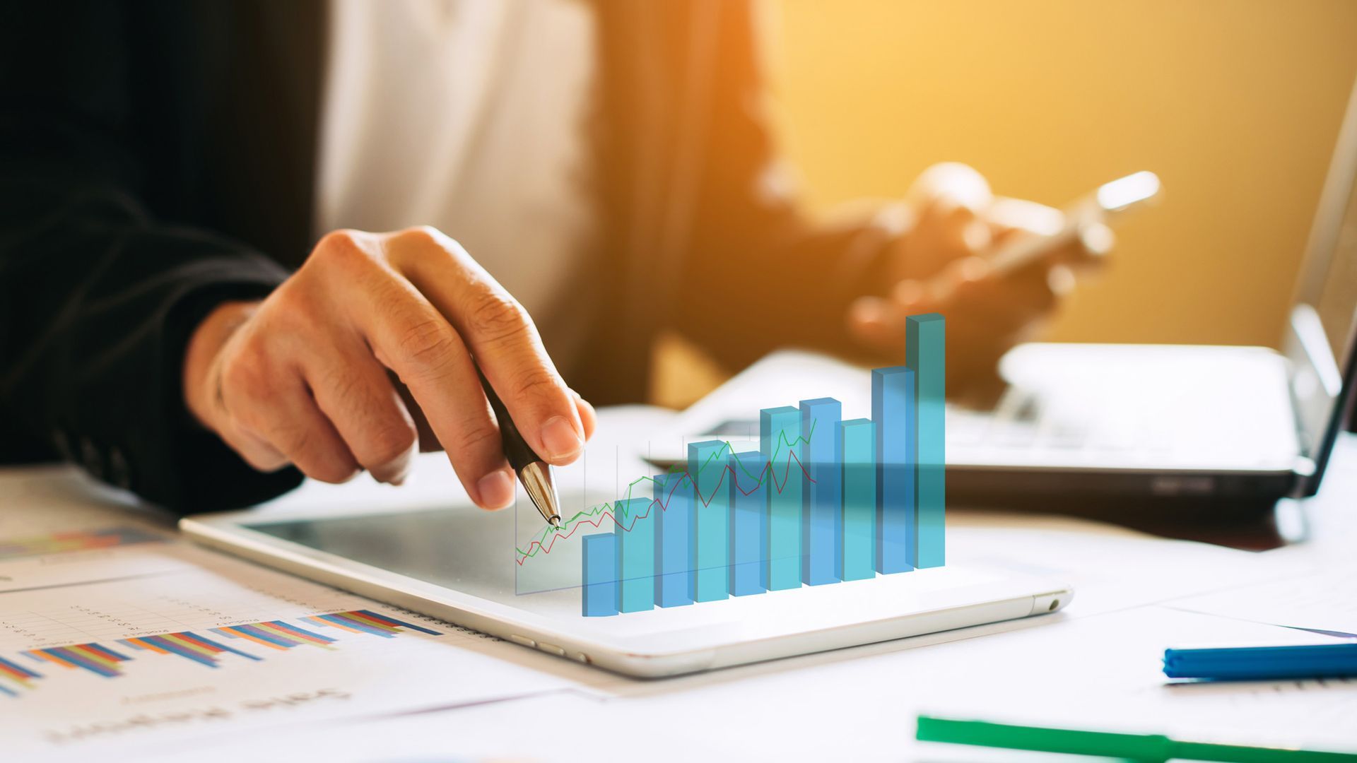 A person is pointing at a graph on a tablet.