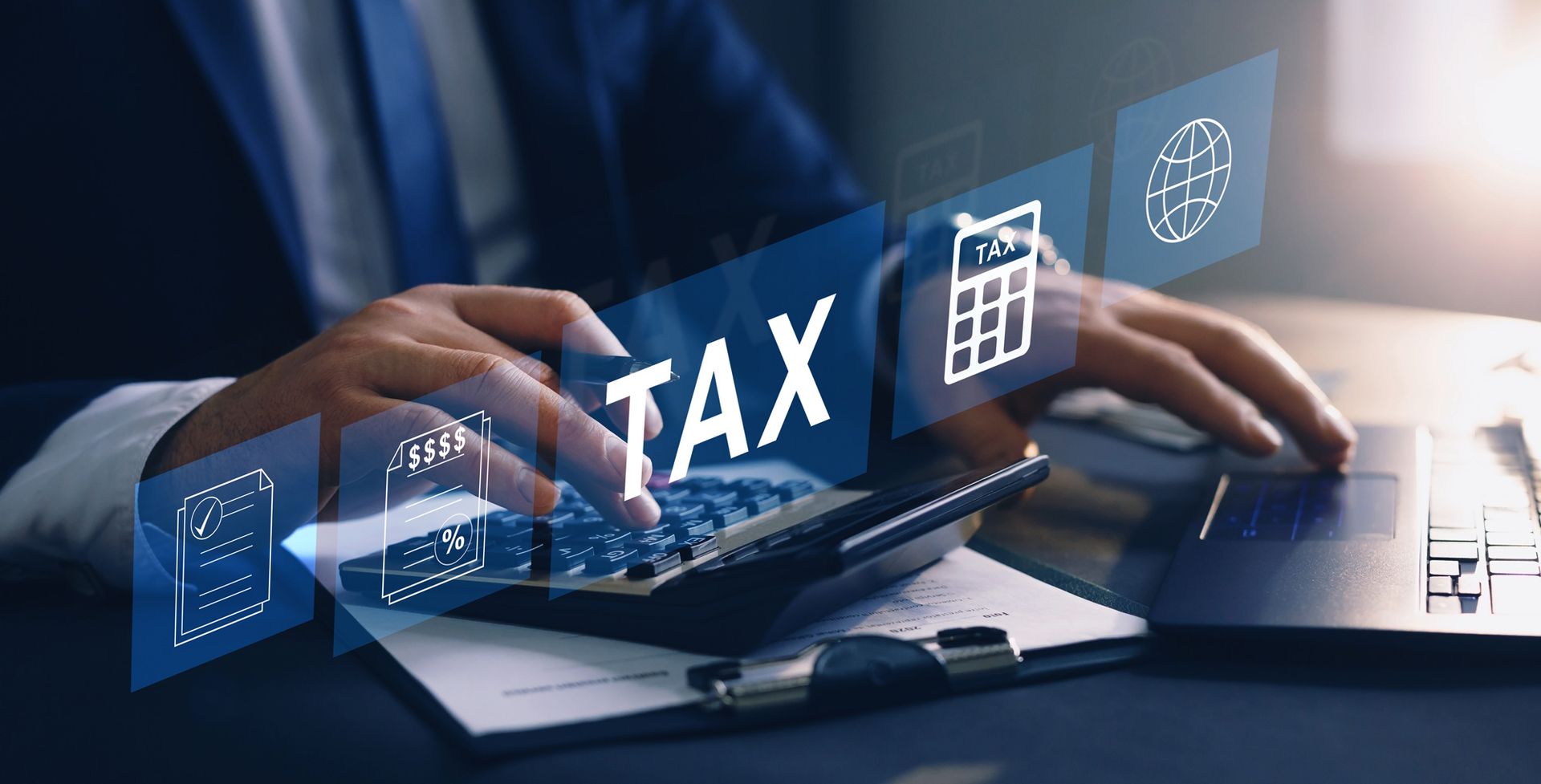 A man is typing on a calculator with the word tax coming out of it.
