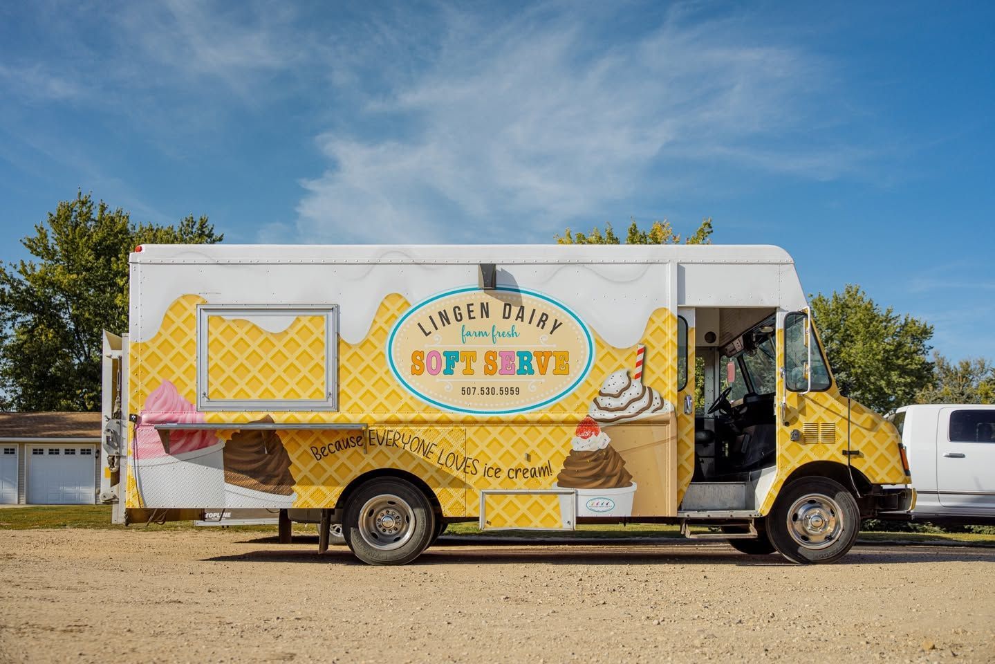A food truck that says not milk is parked in front of a building.