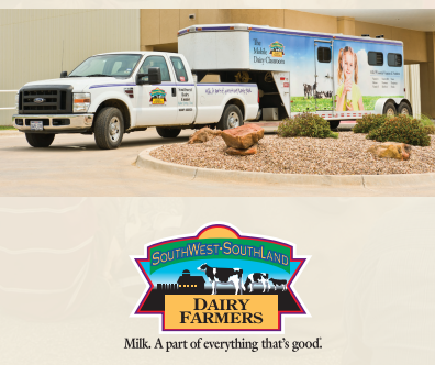 A man in a cowboy hat stands behind a display of clothes