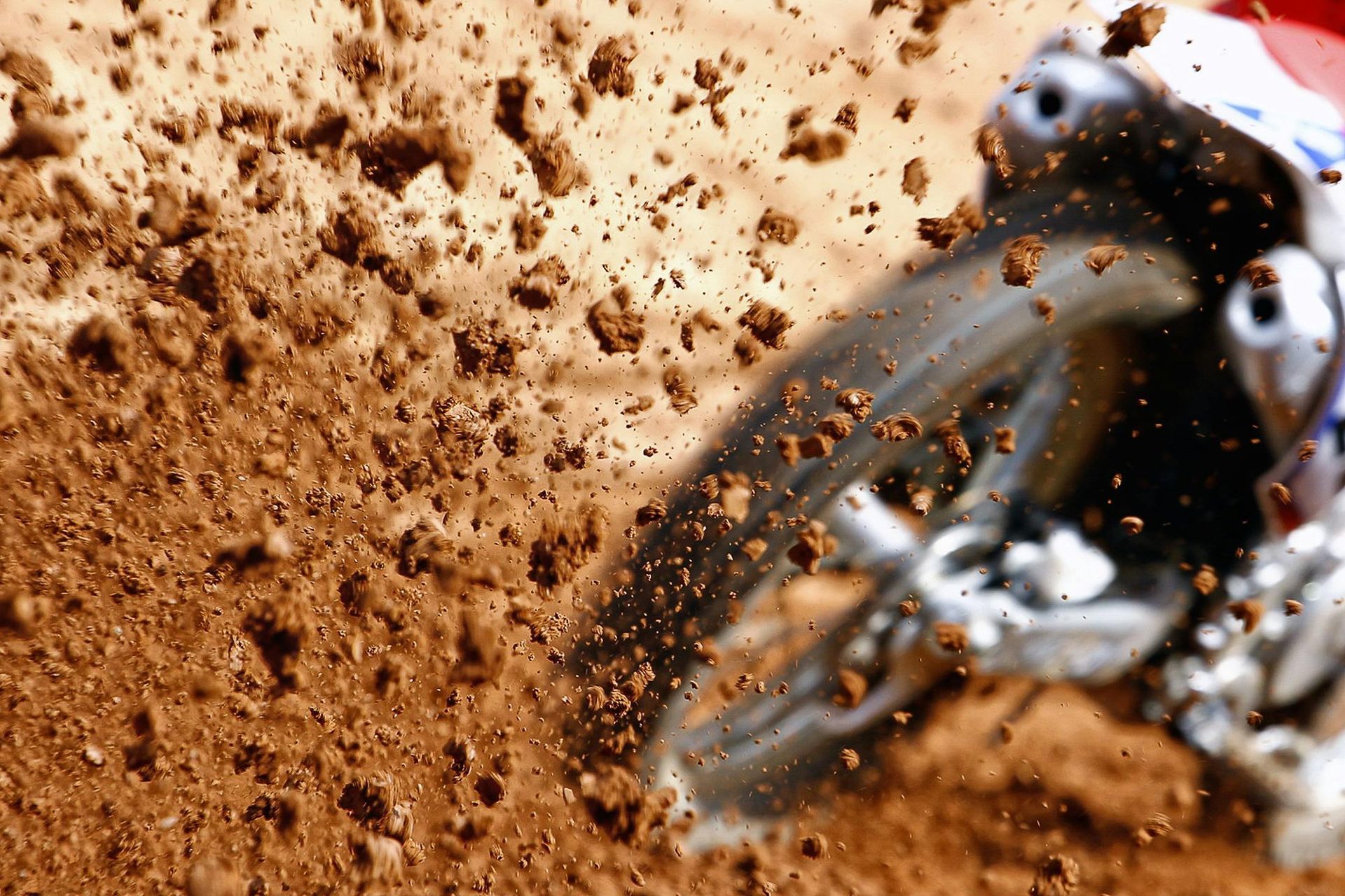 A person is riding a dirt bike in the dirt.