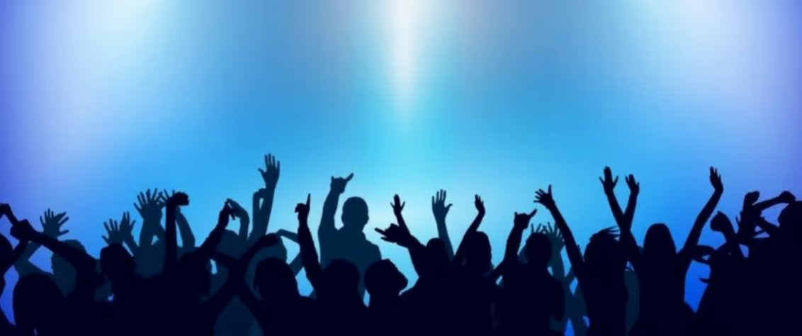 Silhouetted crowd with raised arms against a blue background.