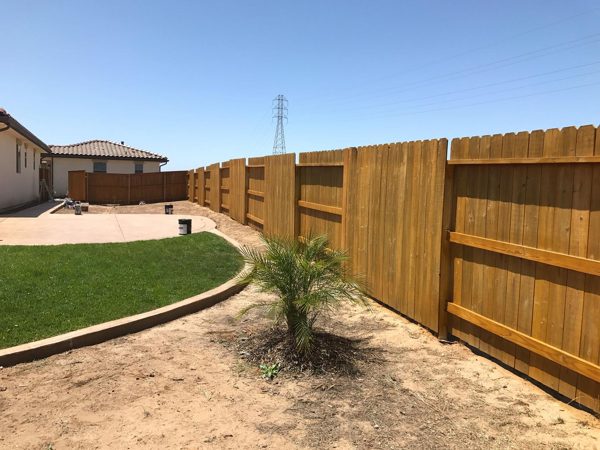 A wooden fence with a gate attached to it.
