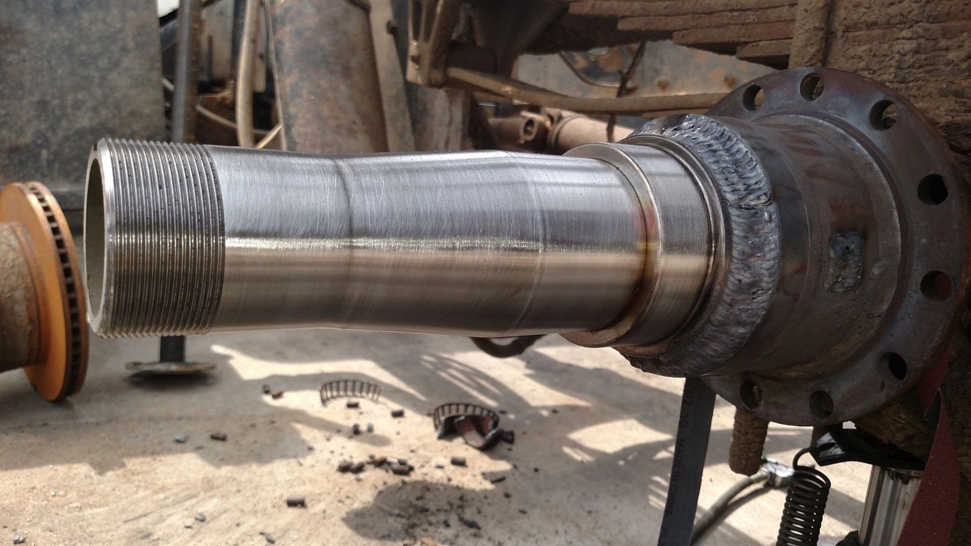 A close up of a metal pipe with a flange on it