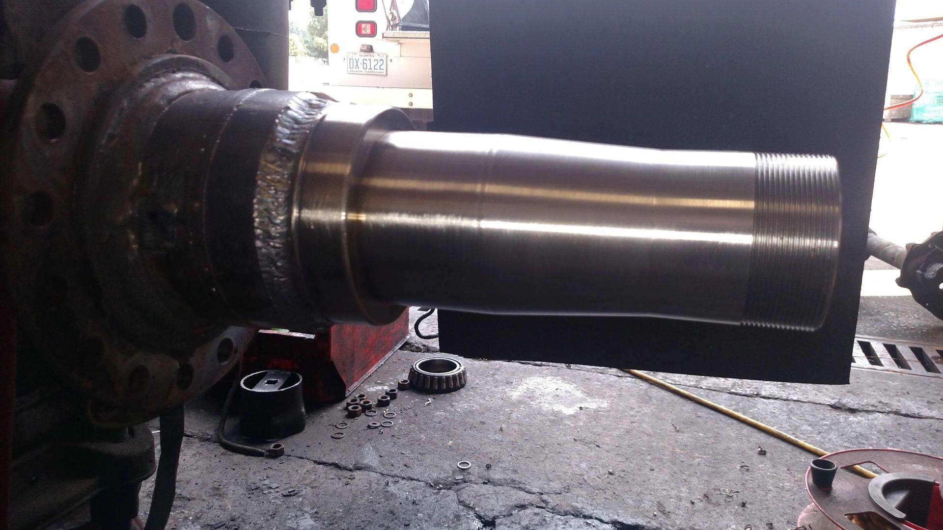 A large metal object is sitting on a concrete surface.