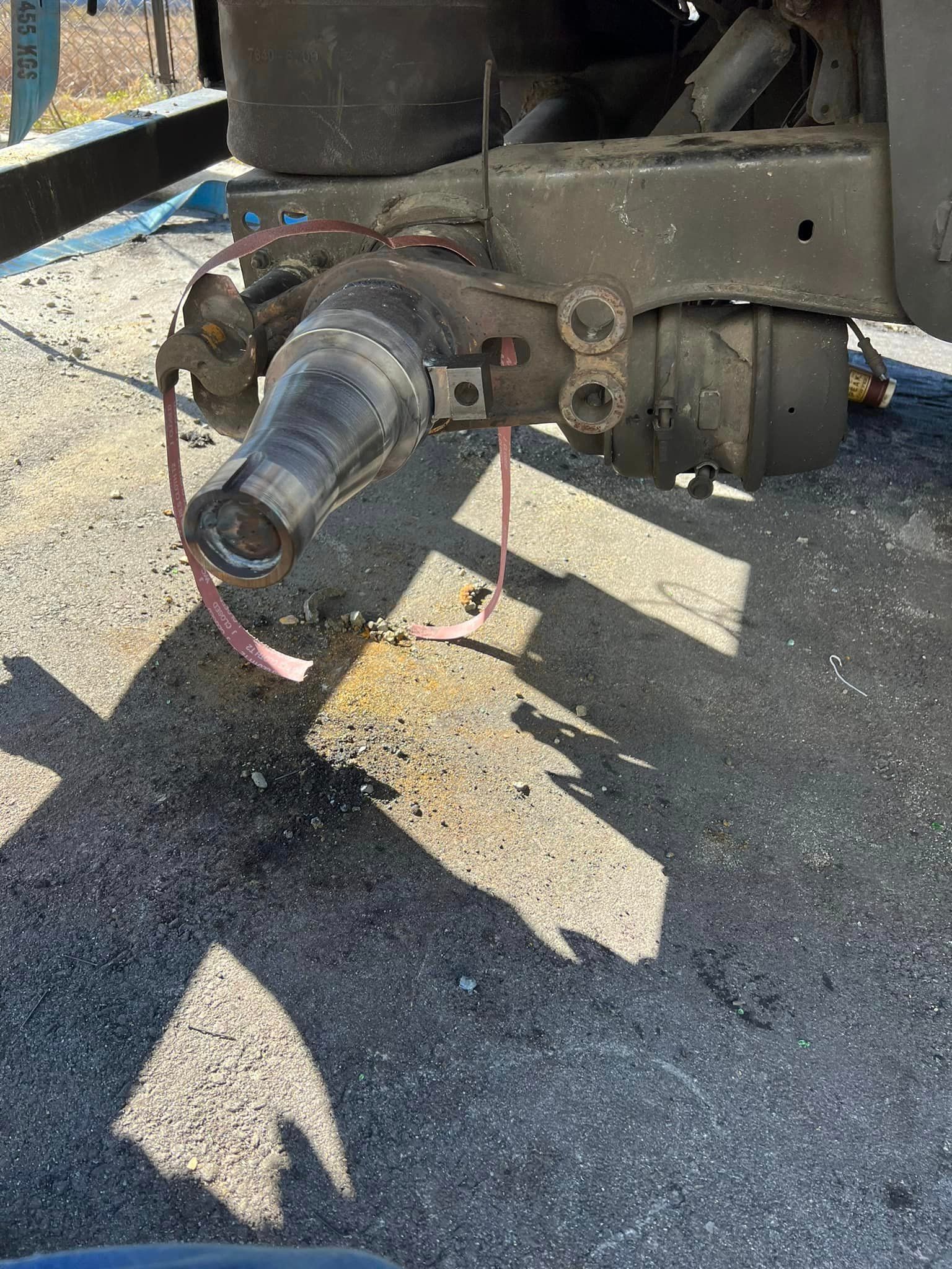 A close up of a vehicle 's exhaust pipe on the ground.