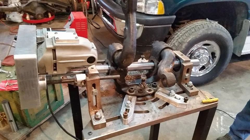 A machine is sitting on a table in front of a truck.