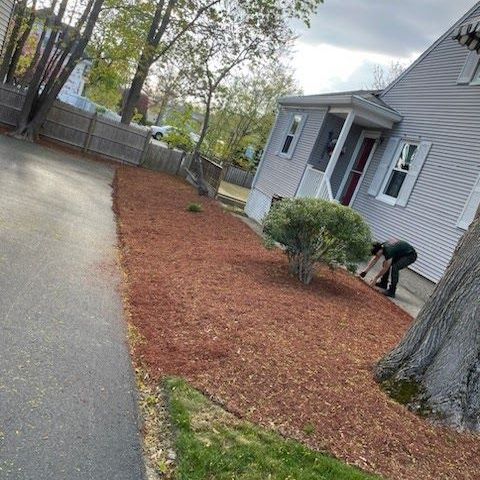 A person is kneeling down in front of a house.