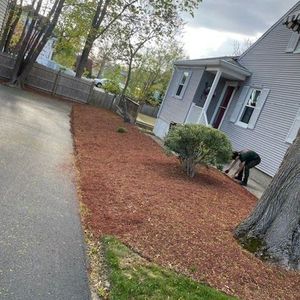 A person is kneeling down in front of a house.
