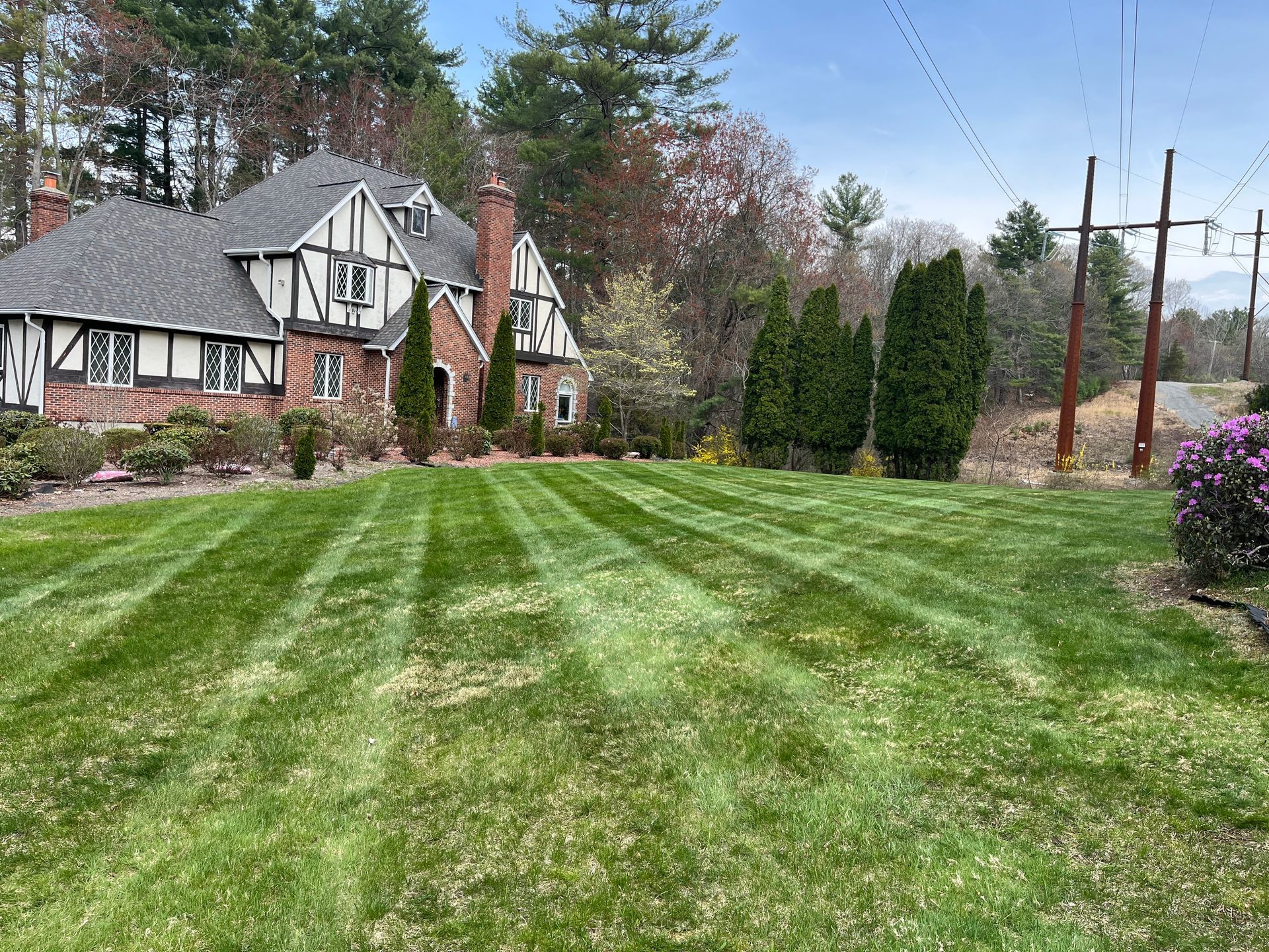 A large house with a lush green lawn in front of it.