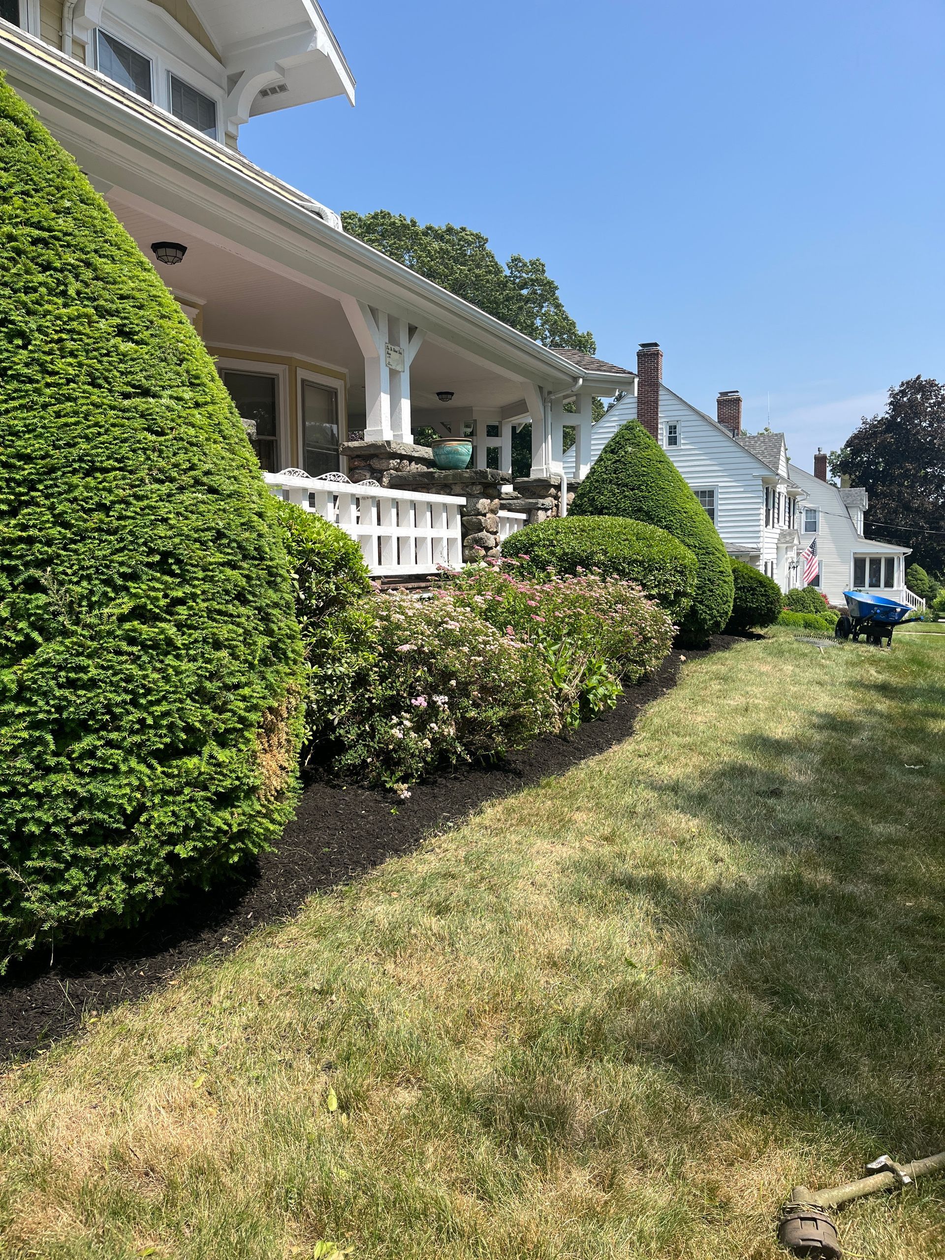 A large white house with a large lawn in front of it.
