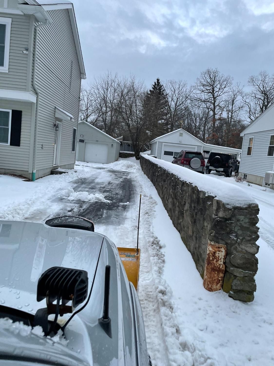 A white truck is parked in a parking lot next to a building.