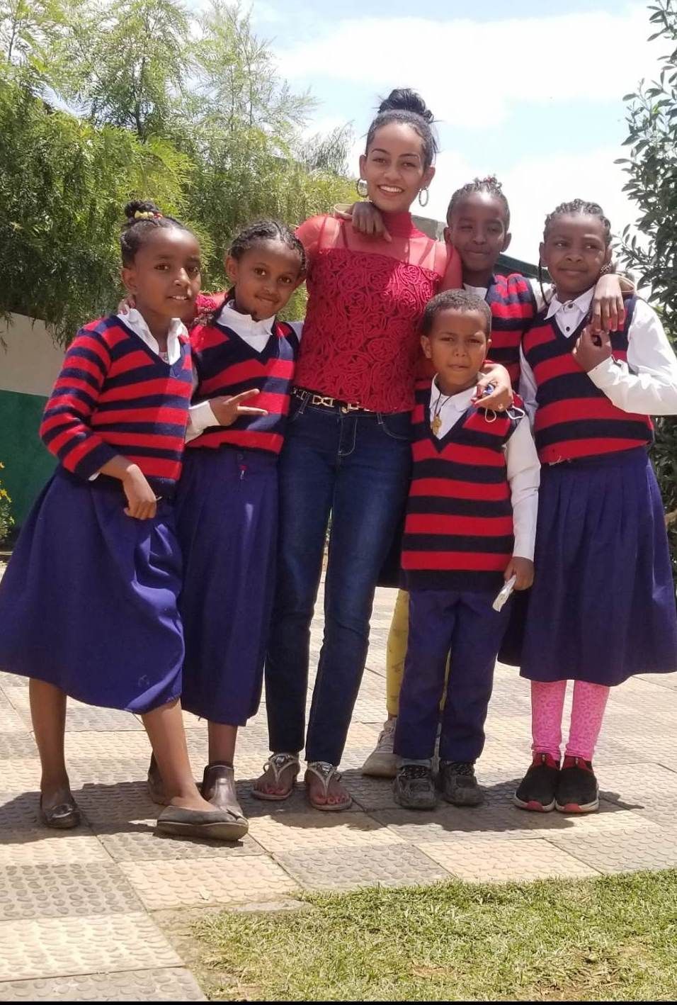 Smiling students in Ethiopia with their teacher