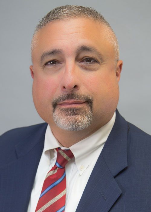 A man with a beard wearing a suit and tie